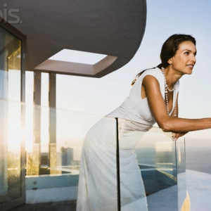 Woman leaning on glass railing