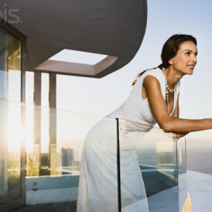 Woman leaning on glass railing Woman leaning on glass railing